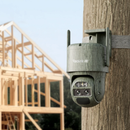 Reolink Trackmix LTE-C. Security camera mounted on a wooden post with a house under construction in the background